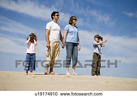 Stock Image - Family taking a walk on the sand, Grand Beach Provincial Park, Manitoba, Canada. Fotosearch