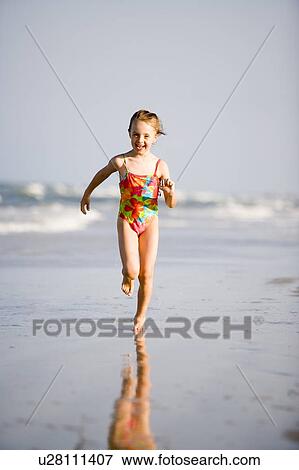 Stock Photo - Girl - (6) running on the beach, Jacksonville, Florida. Fotosearch