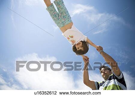 Man swings girls through the air, Grand Beach Provincial Park, Manitoba, Canada View Large Photo Image Stock Image - Man swings girls through the air, Grand Beach Provincial Park, Manitoba, Canada. Fotosearch