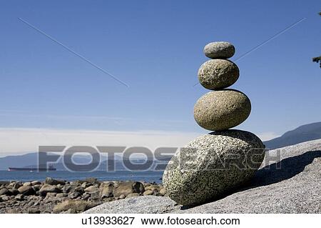 Stock Photo - Rocks stacked on beach, English Bay, Vancouver BC. Fotosearch