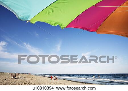 View of beach umbrella and tourists on beach, New Jersy, USA. View Large Photo Image Picture - View of beach umbrella and tourists on beach, New Jersy, USA.. Fotosearch