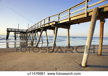 View of pier and beach at sunrise, New Jersy, USA. View Large Photo Image Stock Image - View of pier and beach at sunrise, New Jersy, USA.. Fotosearch