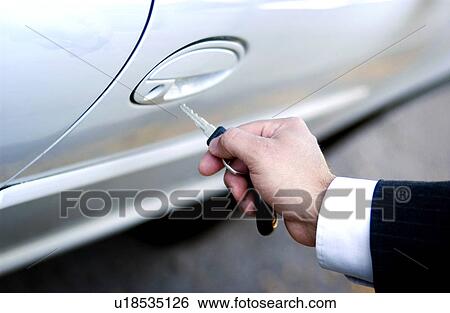Businessman locking or unlocking car door View Large Photo Image Stock Photograph - Businessman locking or unlocking car door. Fotosearch