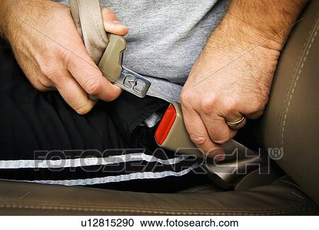 Stock Image - Man buckling his seatbelt. Fotosearch