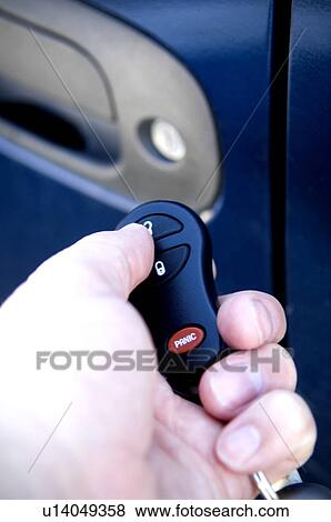Stock Photo - Man unlocking car door. Fotosearch