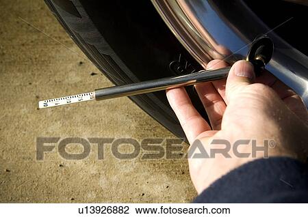 Person checking tire pressure View Large Photo Image Stock Image - Person checking tire pressure. Fotosearch