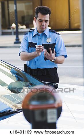 Stock Photo - Policeman writing parking ticket. Fotosearch
