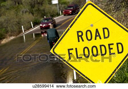 Vehicle driving on flooded road View Large Photo Image Picture - Vehicle driving on flooded road. Fotosearch