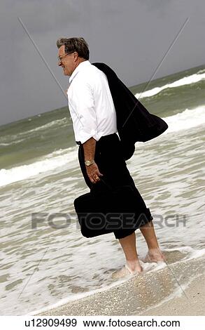 Stock Photo - Businessman at the beach. Fotosearch
