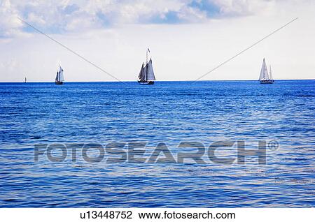 Stock Image - Sailboats on water. Fotosearch