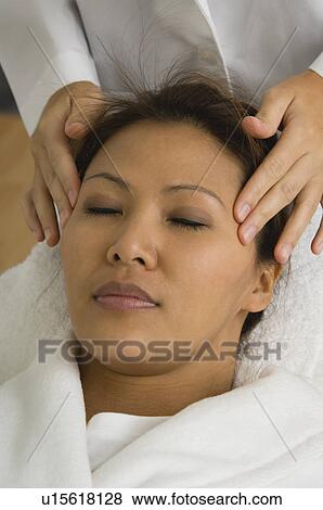Stock Photo - Asian woman getting a massage. Fotosearch