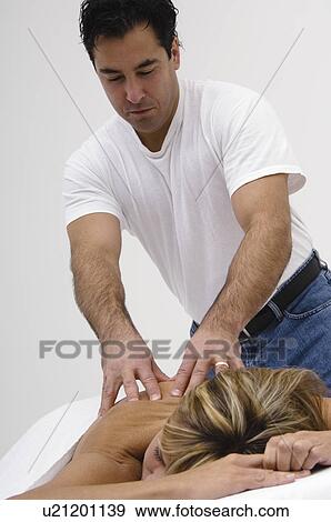 Stock Photo - Man giving woman massage. Fotosearch