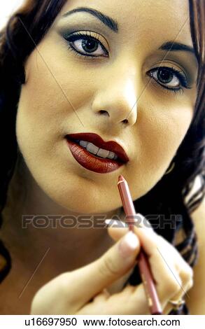 Woman applying makeup View Large Photo Image Stock Image - Woman applying makeup. Fotosearch