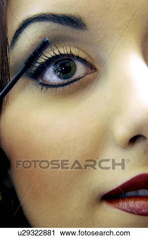 Stock Image - Woman applying makeup. Fotosearch