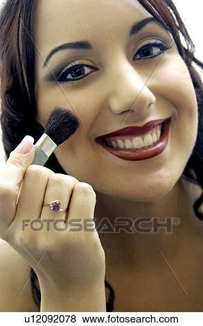 Stock Photo - Woman applying makeup. Fotosearch