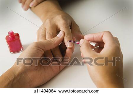 Picture - Woman getting a manicure. Fotosearch