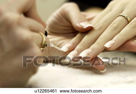 Stock Image - Woman getting a manicure. Fotosearch