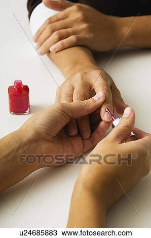 Stock Image - Woman getting a manicure. Fotosearch