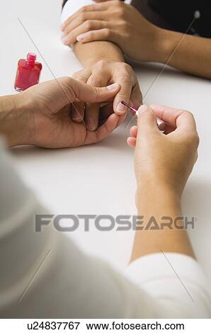 Stock Photo - Woman getting a manicure. Fotosearch