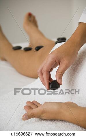 Woman receiving stone therapy View Large Photo Image Stock Photo - Woman receiving stone therapy. Fotosearch