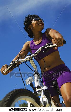 African American woman riding bike Stock Image | u24950323 | Fotosearch