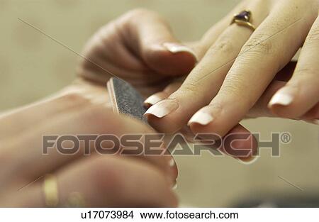 Woman getting a manicure View Large Photo Image Picture - Woman getting a manicure. Fotosearch