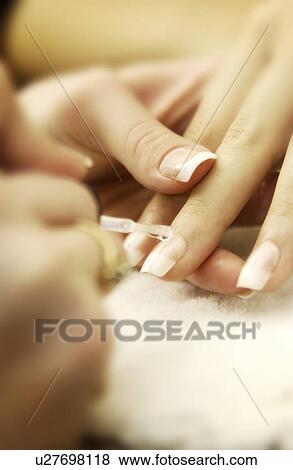 Stock Photo - Woman getting a manicure. Fotosearch