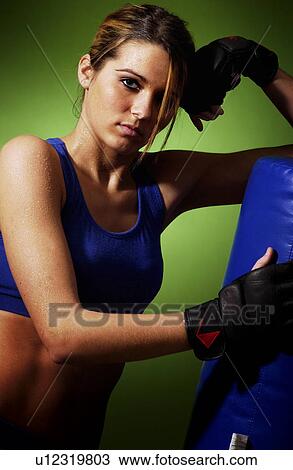 Stock Image - Woman practicing boxing. Fotosearch