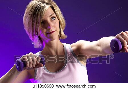 Stock Image - Woman with weights. Fotosearch