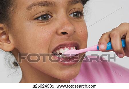 Stock Photography - Young African American girl brushing teeth. Fotosearch