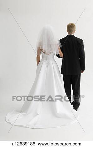Stock Photograph - Back of bride and groom. Fotosearch
