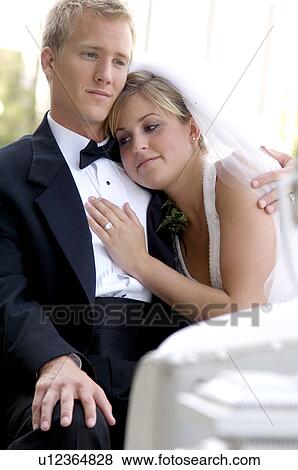 Stock Photo - Bride and groom on horse and carriage ride. Fotosearch