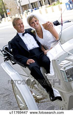 Bride and groom on horse drawn carriage ride View Large Photo Image Stock Photo - Bride and groom on horse drawn carriage ride. Fotosearch