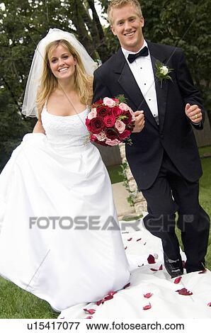 Stock Photo - Bride and groom running down the aisle. Fotosearch