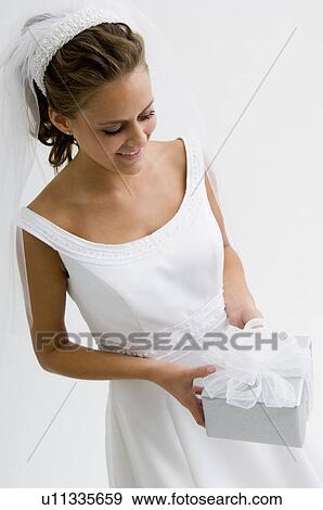 Bride holding gift View Large Photo Image Stock Photo - Bride holding gift. Fotosearch