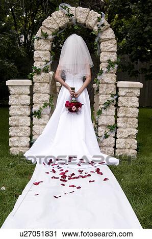 Stock Image - Bride standing in aisle. Fotosearch