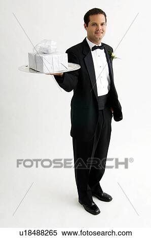 Man holding gift on silver platter View Large Photo Image Stock Photography - Man holding gift on silver platter. Fotosearch