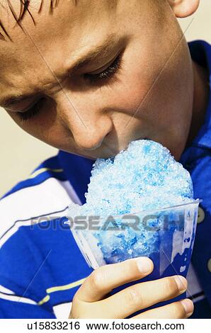 Boy eating carnival food View Large Photo Image Stock Photograph - Boy eating carnival food. Fotosearch
