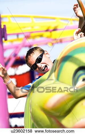 Boy on carnival ride View Large Photo Image Stock Photo - Boy on carnival ride. Fotosearch