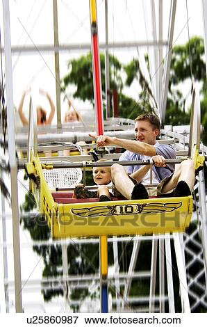 Father and son on ferris wheel View Large Photo Image Stock Photo - Father and son on ferris wheel. Fotosearch