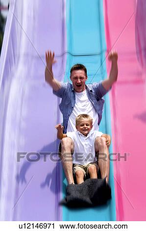 Stock Image - Father and son on slide. Fotosearch