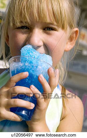 Stock Photo - Girl eating carnival food. Fotosearch
