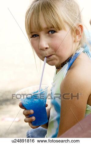 Girl eating carnival food View Large Photo Image Stock Photograph - Girl eating carnival food. Fotosearch