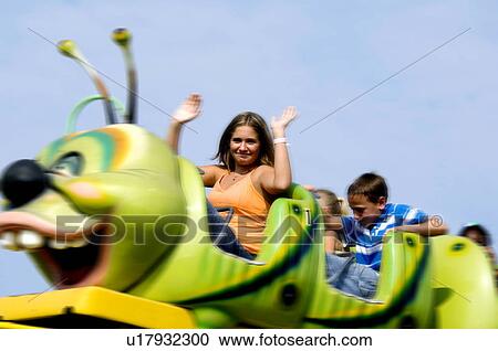 Stock Image - Kids on a carnival ride. Fotosearch