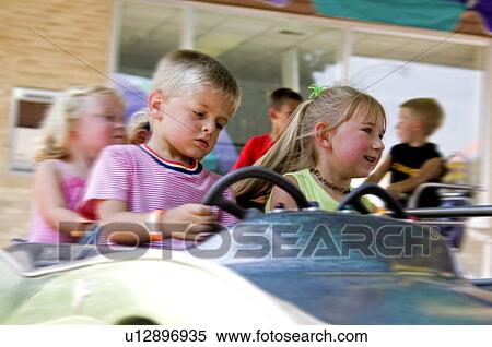 Kids on carnival ride View Large Photo Image Stock Photography - Kids on carnival ride. Fotosearch