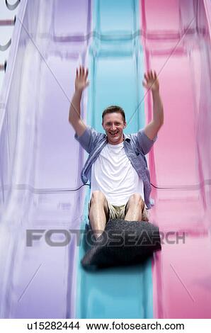 Man going down carnival slide View Large Photo Image Picture - Man going down carnival slide. Fotosearch