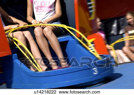 Stock Image - People on carnival ride. Fotosearch