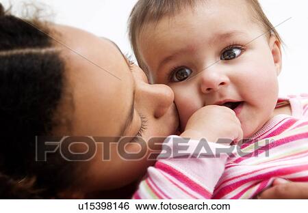 Stock Photograph - African American girl holding baby. Fotosearch