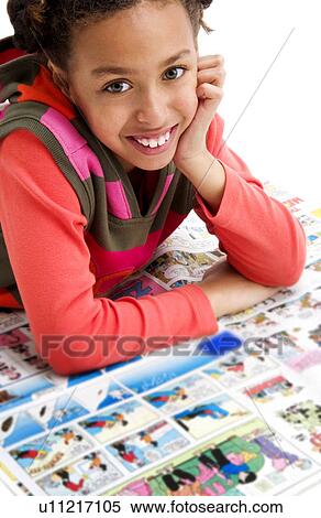 Stock Photography - African American girl reading newspaper. Fotosearch