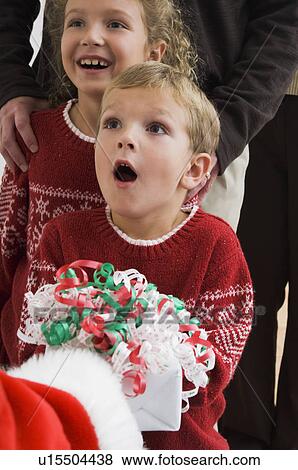 Stock Photo - Boy getting a gift from Santa. Fotosearch